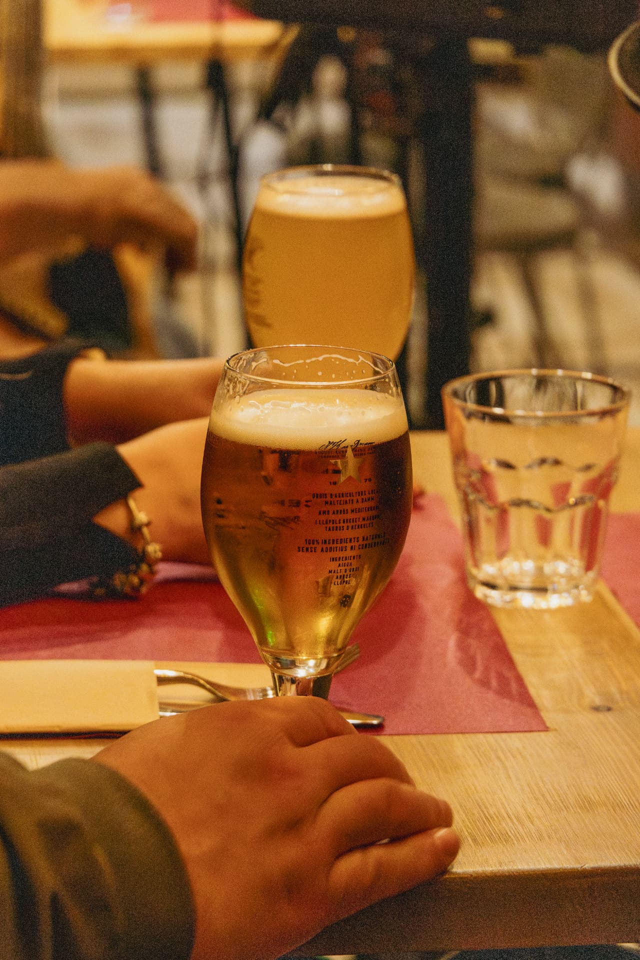 Cerveza en copa sobre mesa de madera en Latitud Cero Sabadell